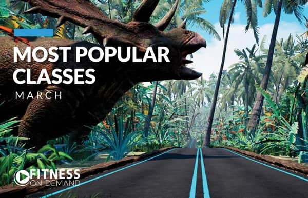 A large dinosaur stands near a tropical road surrounded by lush greenery and palm trees. Text reads Most Popular Classes March and Fitness On Demand with a play button logo.