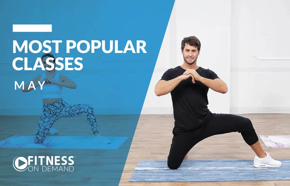A man kneels on a yoga mat, hands together, exercising in a bright studio. Behind a blue overlay, white text reads Most Popular Classes May. The Fitness On Demand logo appears in the bottom left.