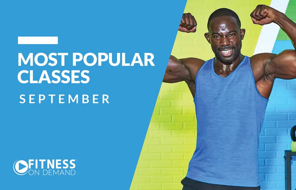 A man in a blue tank top flexes his arms and smiles energetically against a green and blue background. Text reads: “Most Popular Classes September. Fitness On Demand.”.