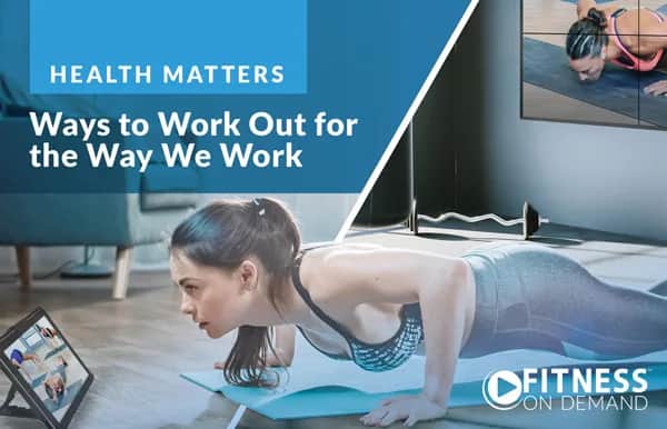 A woman does a plank exercise on a yoga mat at home while looking at a tablet screen showing a fitness class. Text reads, Ways to Work Out for the Way We Work, and FITNESS ON DEMAND.