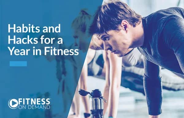 A man and woman are doing push-ups in a gym. The text on the image reads, Habits and Hacks for a Year in Fitness. The Fitness On Demand logo appears in the bottom left corner.