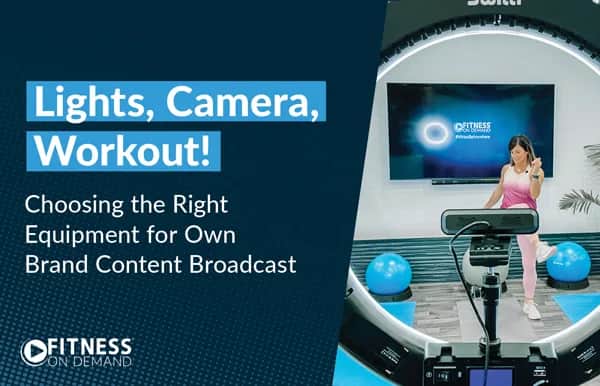 A woman in workout clothes exercises in front of a camera and large screen in a fitness studio. Text reads: “Lights, Camera, Workout! Choosing the Right Equipment for Own Brand Content Broadcast. FITNESS ON DEMAND.”.