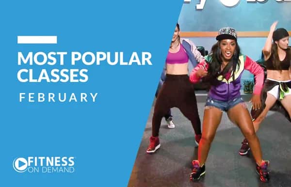 A group of women in activewear dance energetically in a fitness class. Text on a blue background reads, Most Popular Classes February and Fitness On Demand.