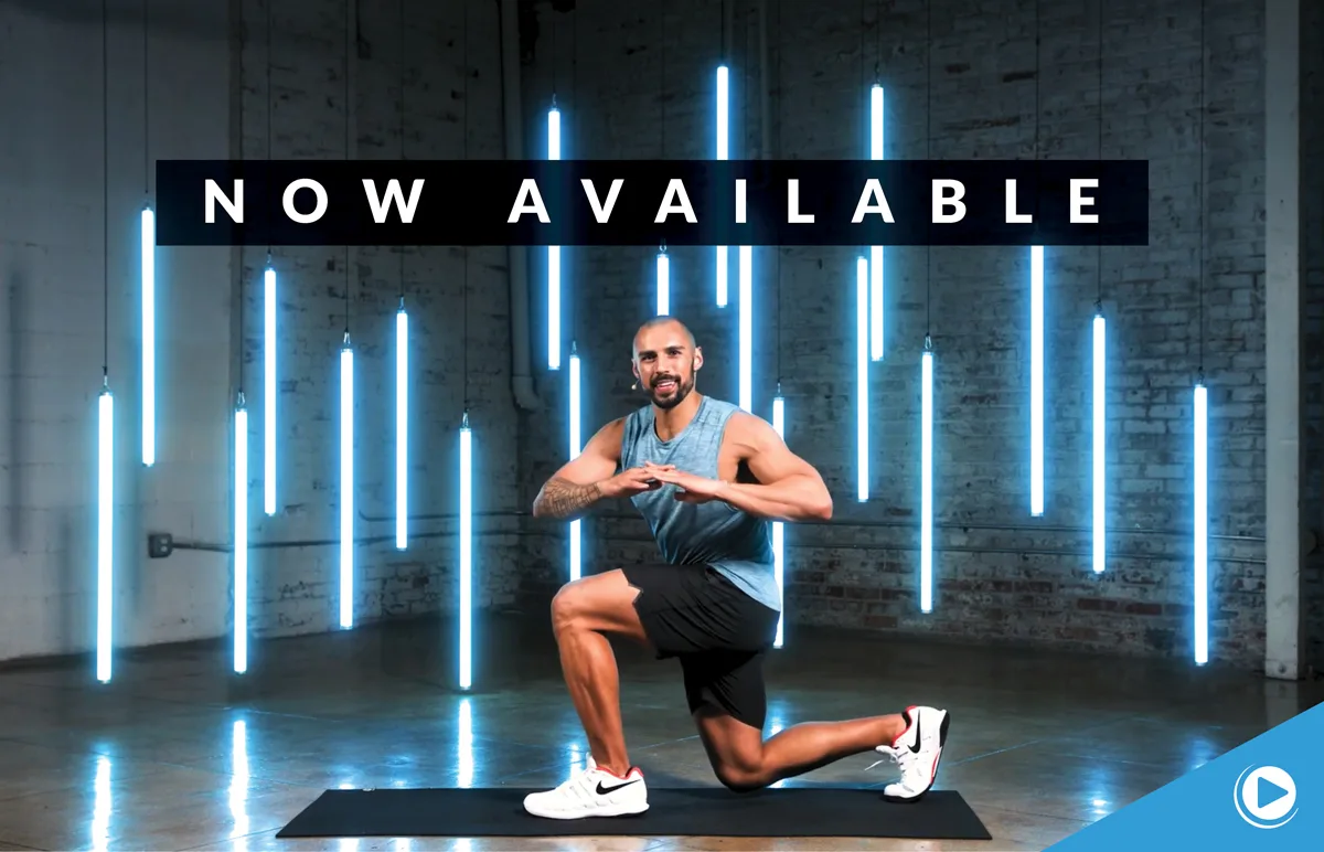 A man in athletic wear kneels on an exercise mat, hands together, in a studio with vertical blue neon lights. Above him, text reads “NOW AVAILABLE.” Play button icon is in the bottom right corner.