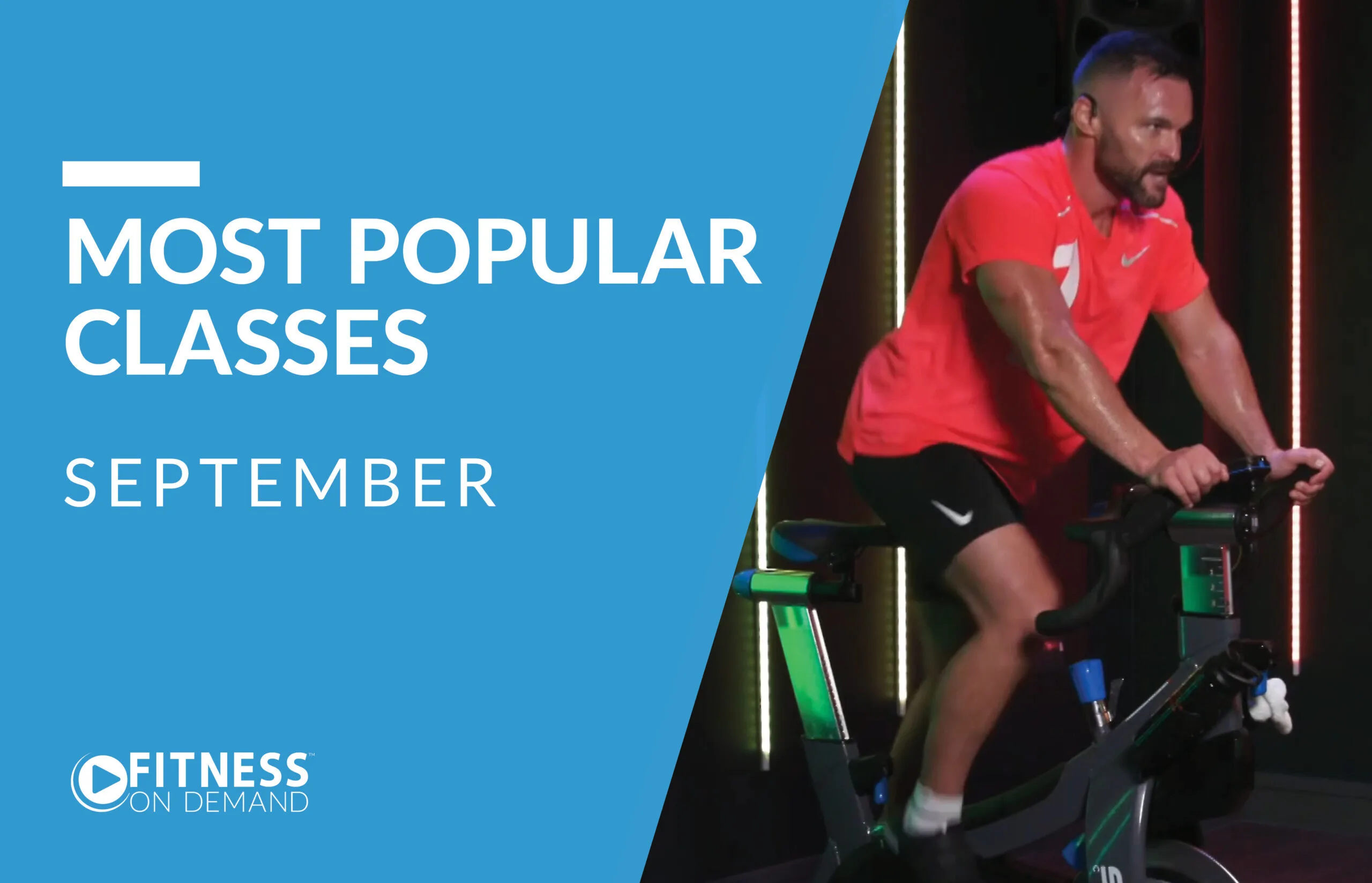 A man in a bright red shirt rides a stationary bike in a fitness studio. Text on a blue background reads Most Popular Classes September and Fitness On Demand.