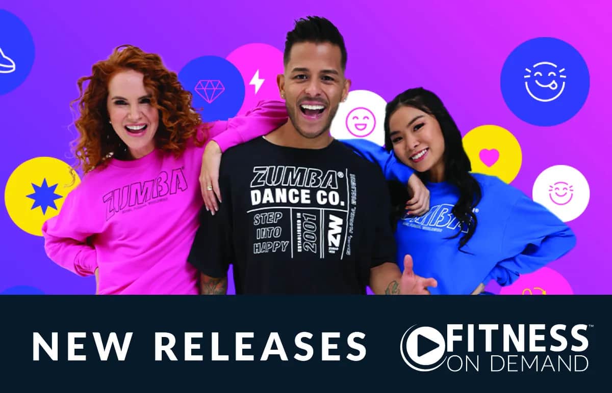 Three energetic people in colorful Zumba shirts smile in front of a bright, playful background with emoji icons. Text below reads “NEW RELEASES” and “FITNESS ON DEMAND.”.