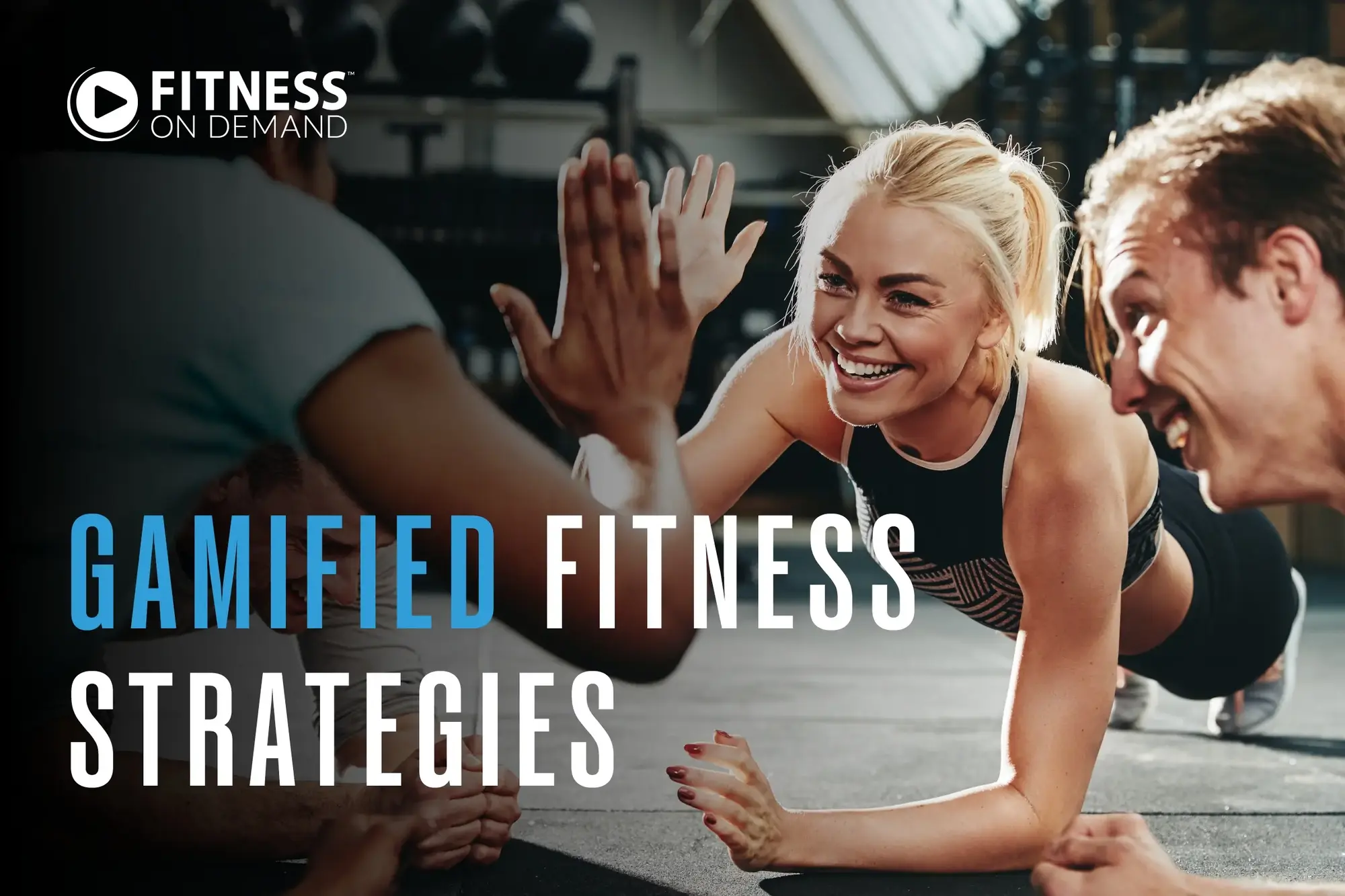 A woman smiling and doing a plank on a gym floor, giving a high-five to a workout partner. Text on the image reads: Gamified Fitness Strategies.