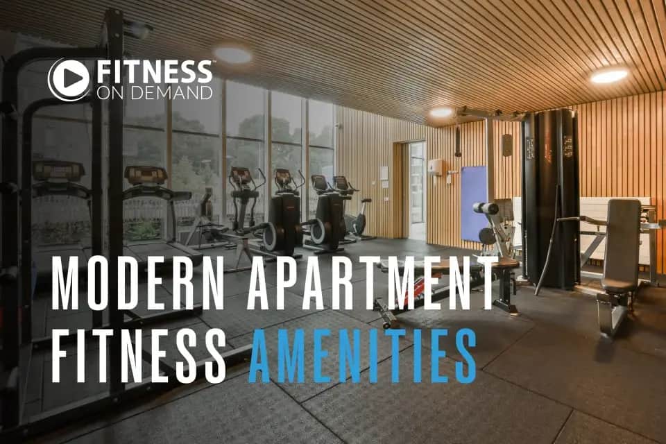 A modern apartment gym with cardio and strength equipment, wooden ceiling, and large windows. Text reads: "Modern Apartment Fitness Amenities."