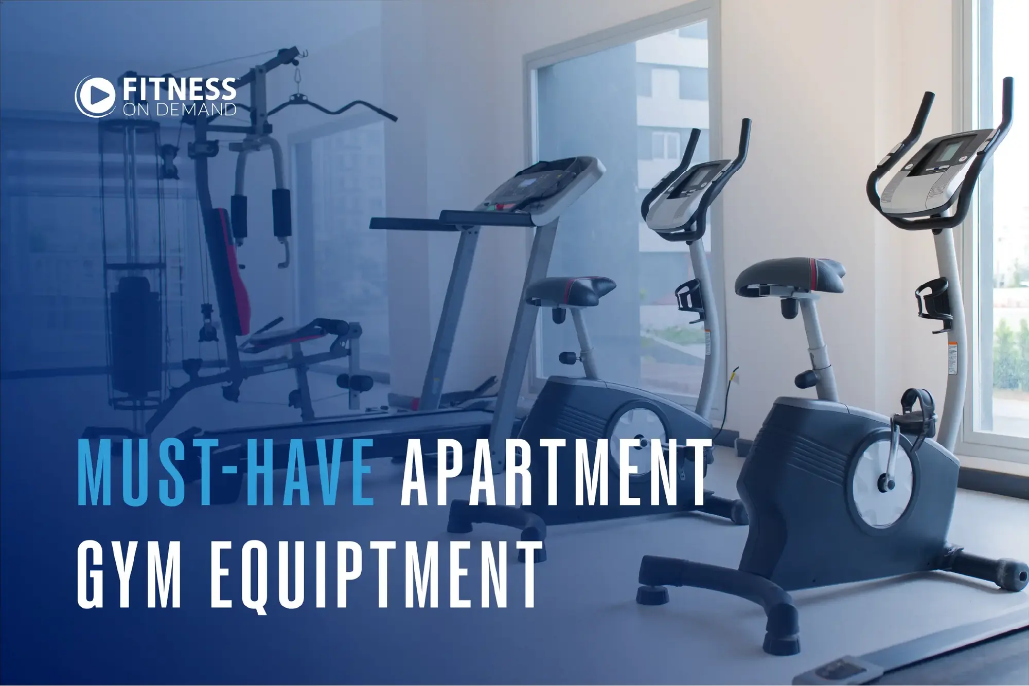 A modern apartment gym with exercise bikes, a treadmill, and a multi-use strength machine. Large windows let in natural light. The text reads, Must-Have Apartment Gym Equipment with the Fitness On Demand logo.