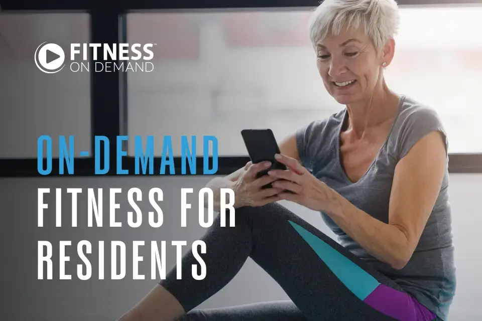 Smiling older woman in workout clothes sits indoors, looking at her smartphone. Text on image reads: "On-demand fitness for residents." A Fitness on Demand logo sits in the top left corner.