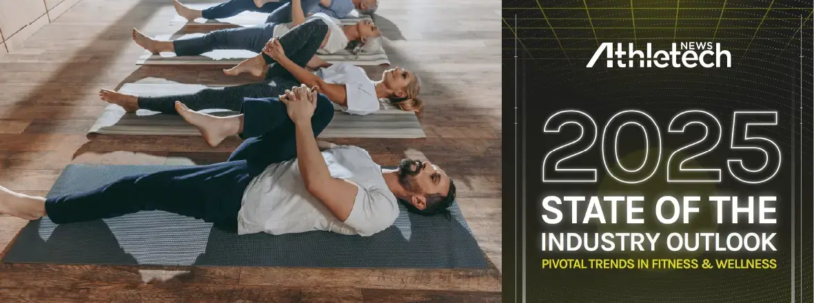 A group of people lying on yoga mats, stretching one leg to their chest in a fitness studio. Next to them is a report titled: 2025 State of the Industry Outlook: Pivotal Trends in Fitness & Wellness. Athletech News.