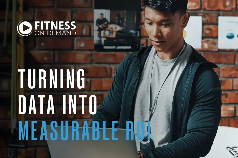 A man wearing workout clothes uses a laptop in a gym. Text reads: "Turning data into measurable ROI."