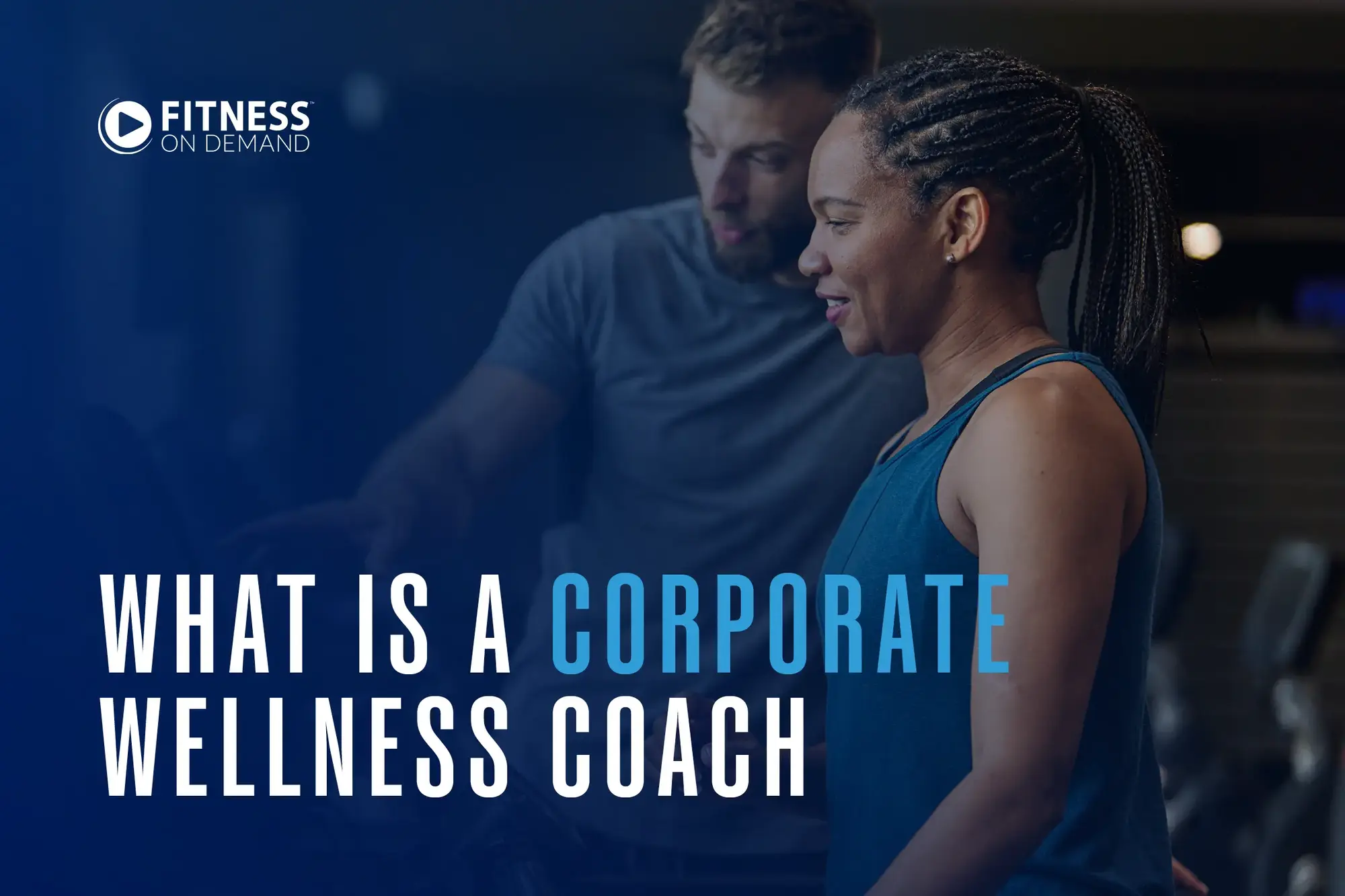 A woman in workout clothes smiles while listening to a corporate wellness coach explaining equipment in a gym setting. Text reads What is a Corporate Wellness Coach with the Fitness On Demand logo in the corner.