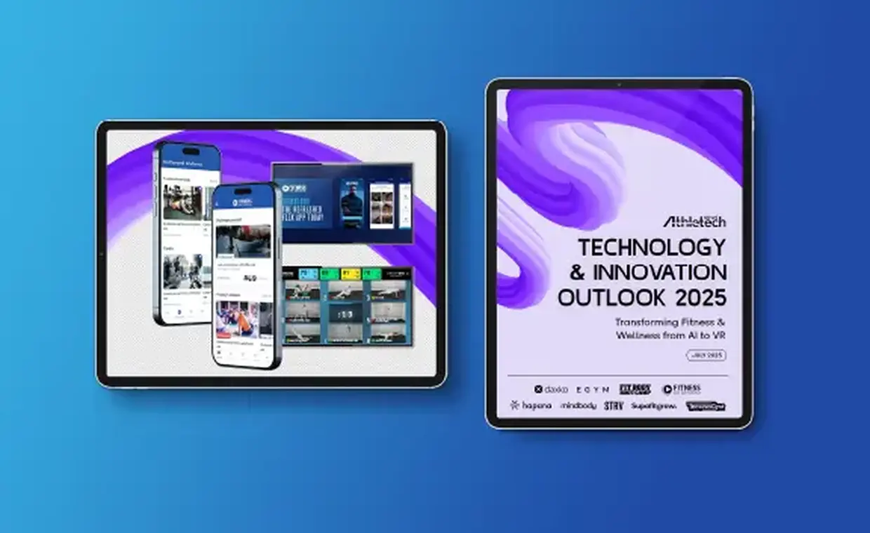 Two tablets display digital fitness and wellness content on blue and purple backgrounds. The right tablet shows a report titled “Technology & Innovation Outlook 2025” by Athletech News.